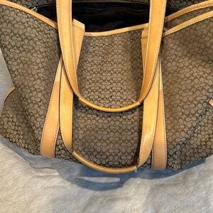 Coach bag. Multiple pockets and zipper. , Dimensions: 19.5” by 13.5”.